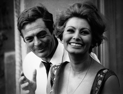 A black and white photo of Marcello Mastroianni and Sophia Loren smiling in the third episode of Yestarday, Today and Tomorrow